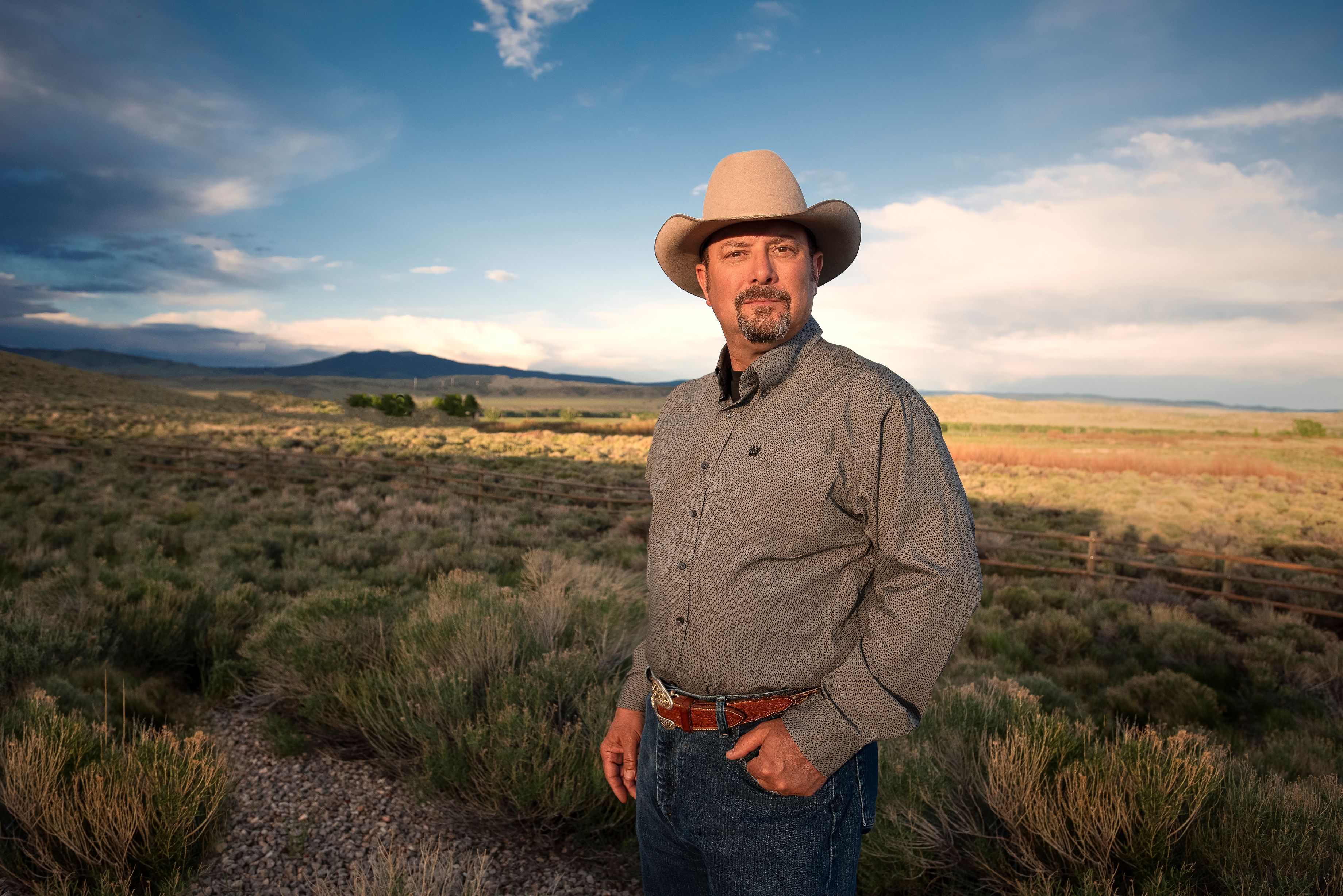 CJ Box with cowboy hat standing on valley background